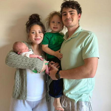 Addie McCracken with her boyfriend, two sons while she was pregnant with another child.